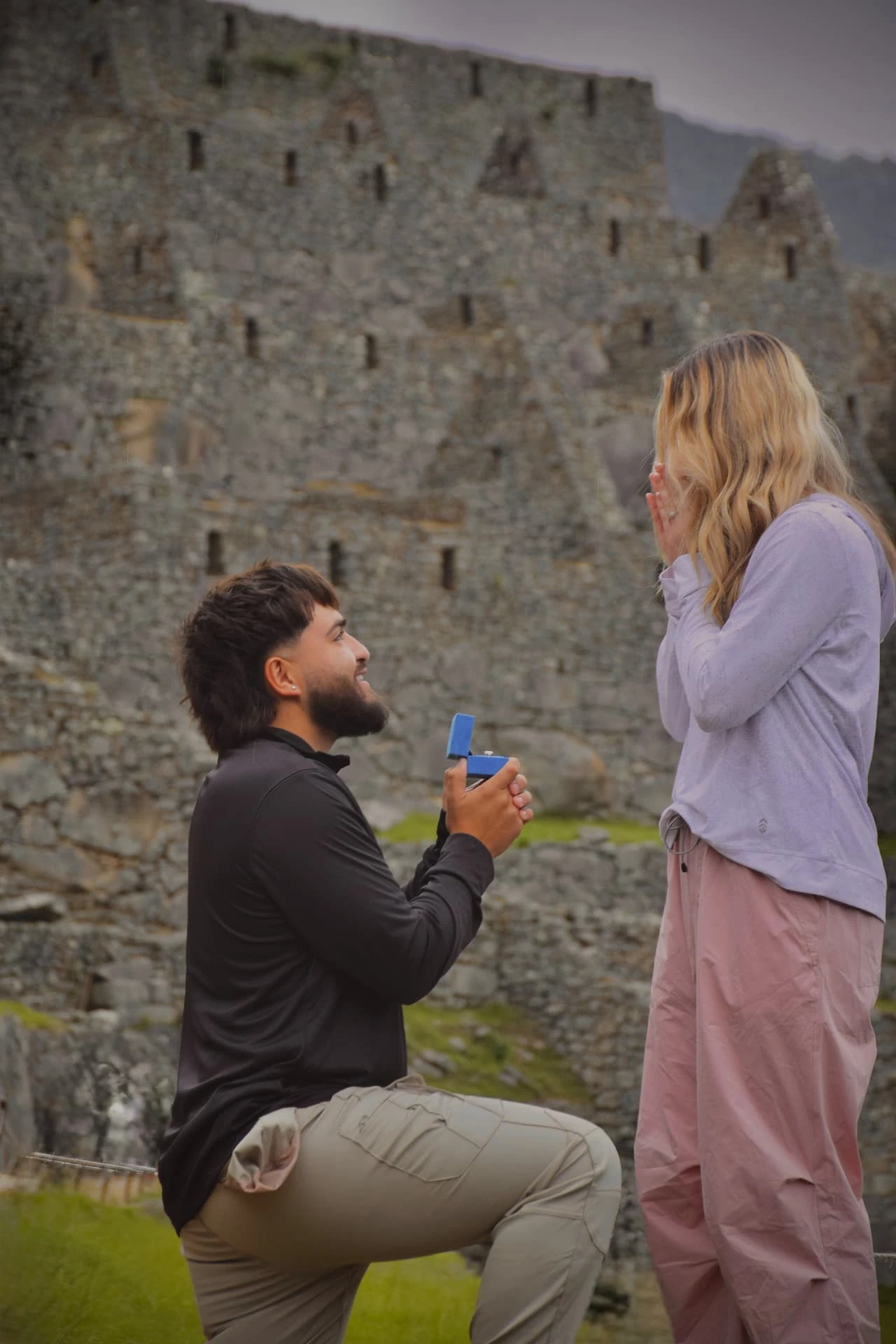 A marriage proposal beside historic stone ruins